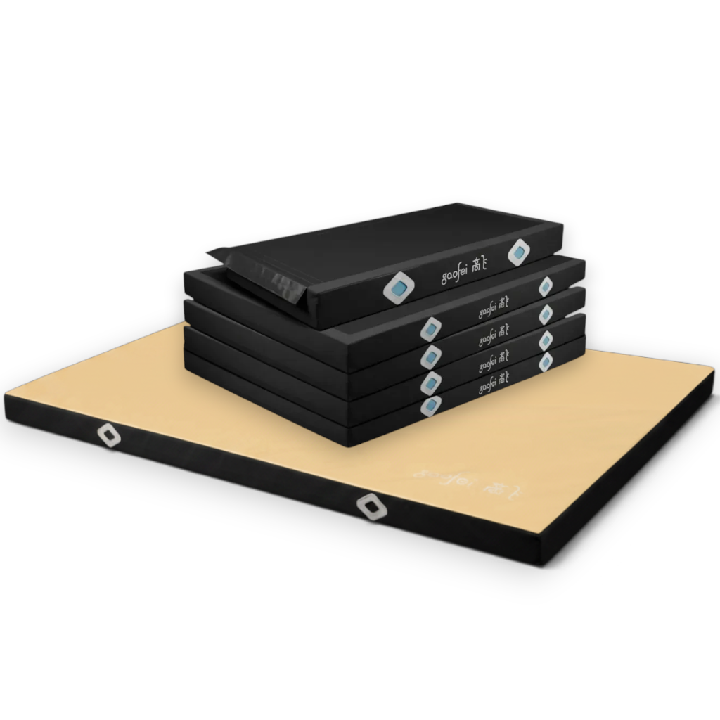 UK Gym Pits FIG approved asymmetric bars landing mats with black base units and a tan soft topper mat.