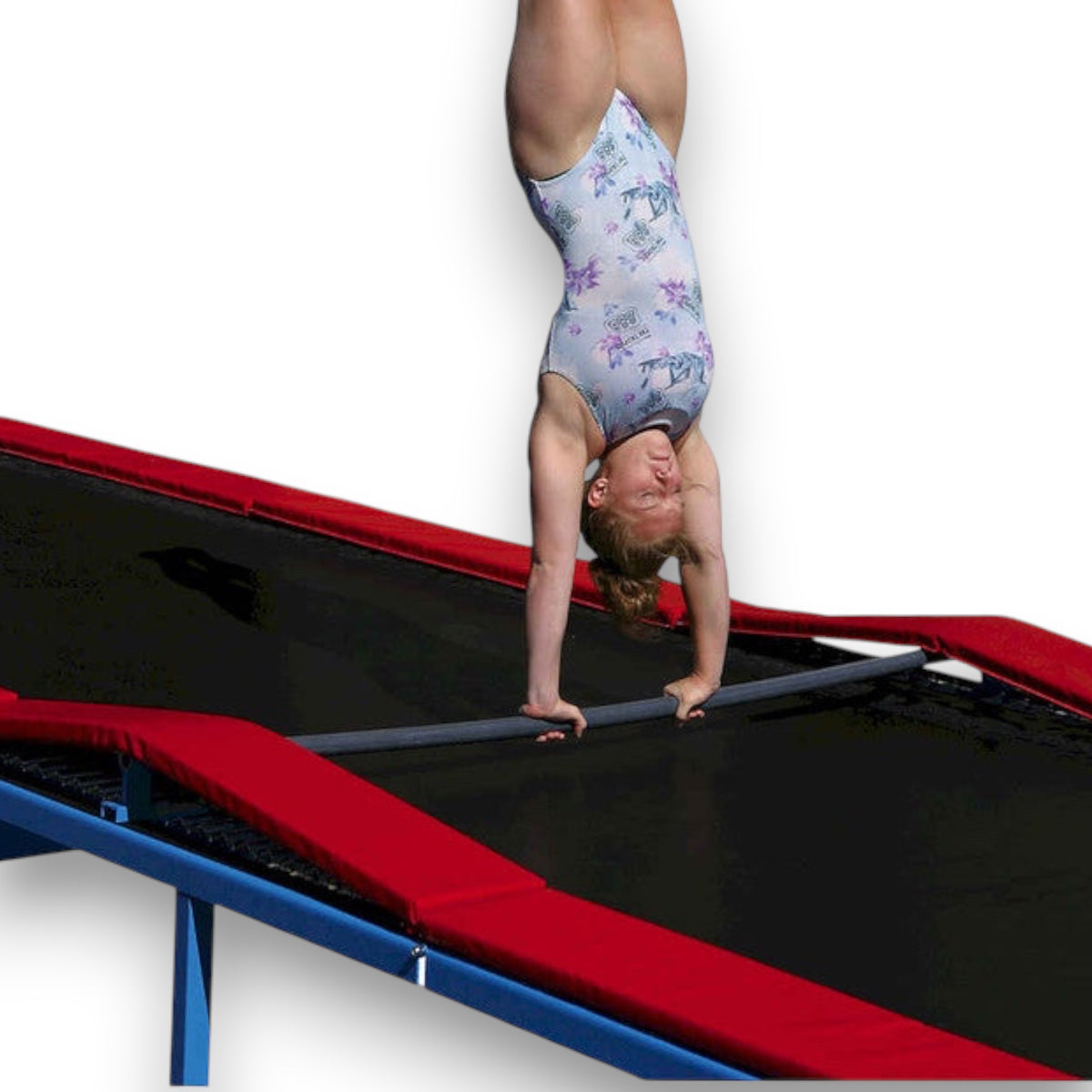 Gymnast performing a handstand on a UK Gym Pits attachment frame bar mounted to a Tumbl Trak for bar skill practice.