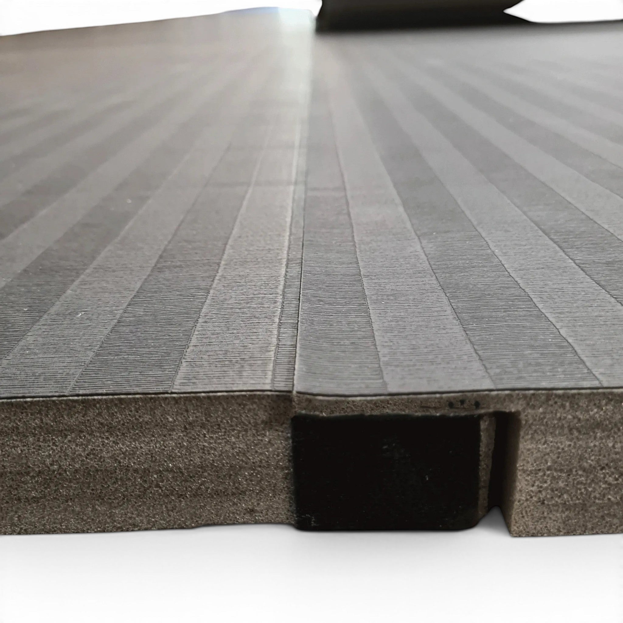 UK Gym Pits black hybrid connect mat roll with tatami-textured PVC surface and integrated Velcro flap for easy joining.