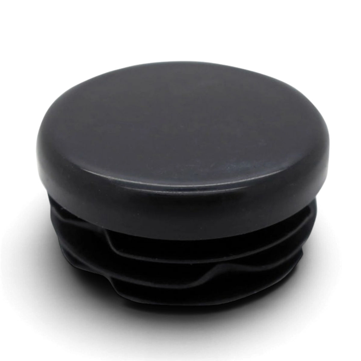 UK Gym Pits black round replacement dust cap for mini trampoline leg braces on a black background