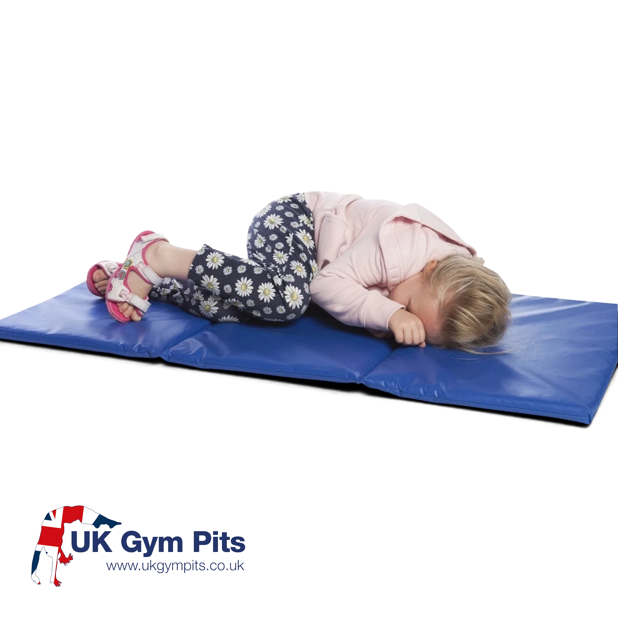 A young girl sleeping on a blue UK Gym Pits folding foam mat designed for gymnastics and soft play activities.