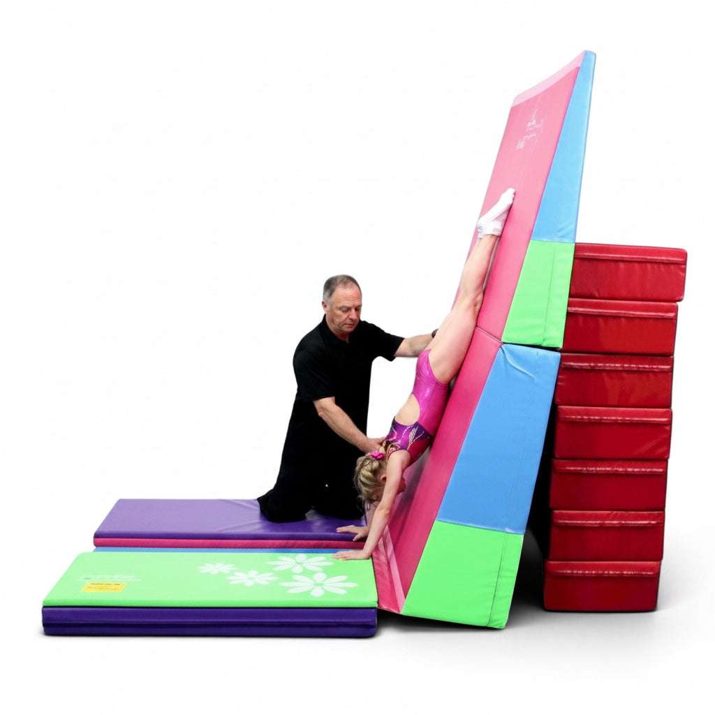 UK Gym Pits Booster Block used by a coach to spot a young gymnast performing a handstand against a training mat
