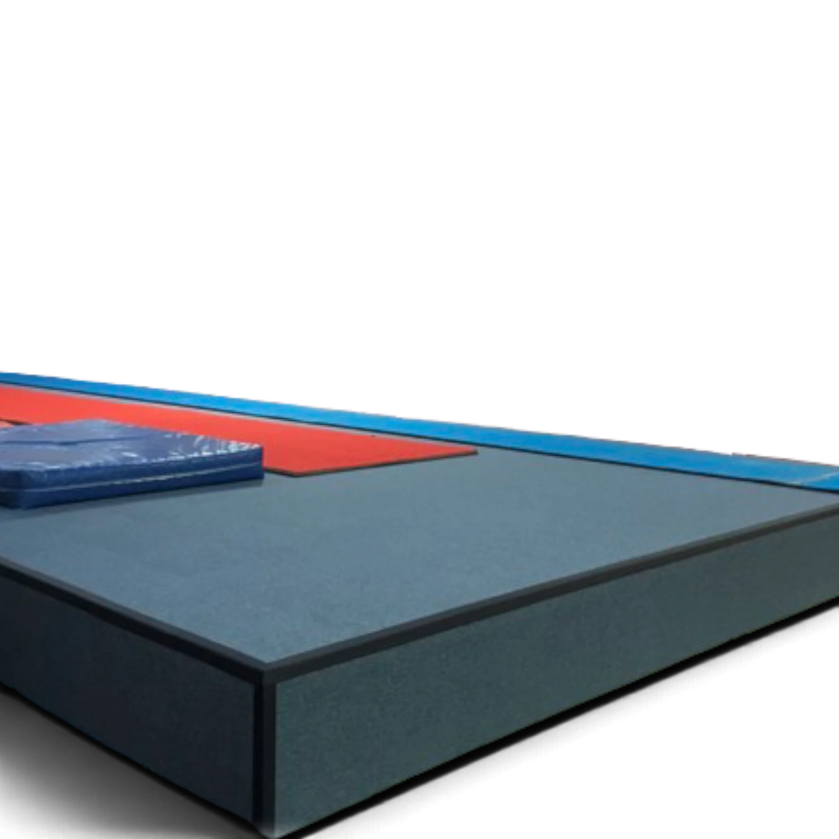 UK Gym Pits heavy duty carpet tiles installed on a gym podium floor with blue and red safety padding