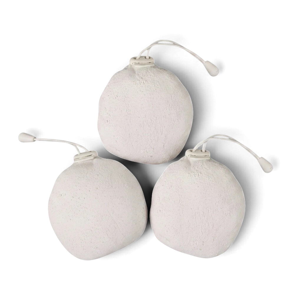 Three UK Gym Pits white powder chalk balls in cotton sacks for improved grip in gymnastics and weight lifting.