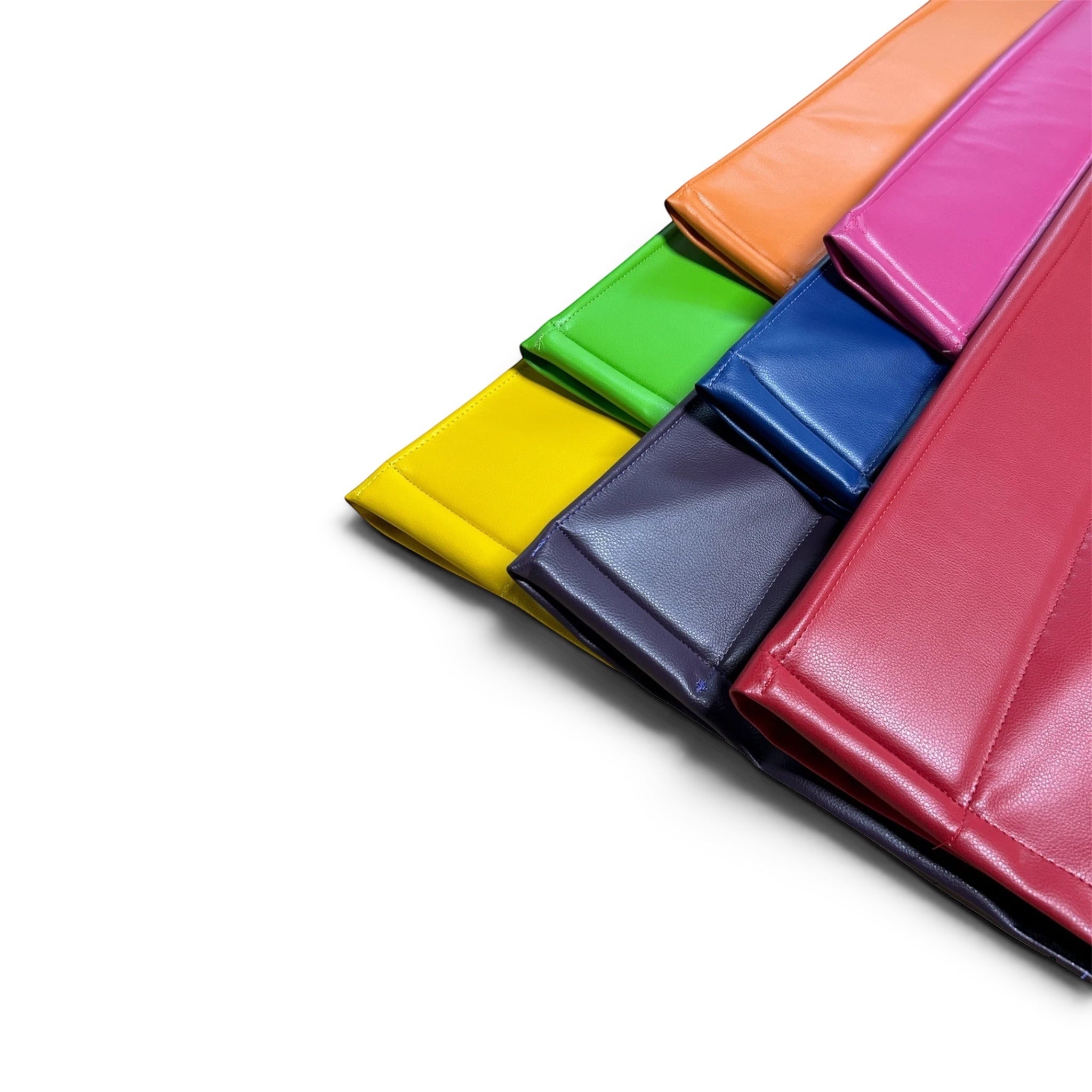 UK Gym Pits cushioned beam mats in various vibrant colours featuring anti-slip faux leather for gymnastics training.