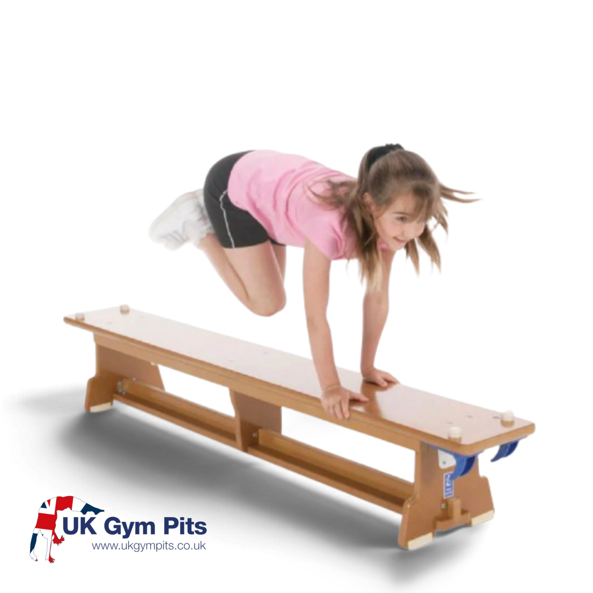 A young girl jumping over a UK Gym Pits wooden Eurobench with non-slip feet and nylon hooks for school gym activities.
