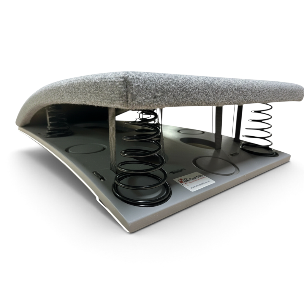 UK Gym Pits FIG approved gymnastics springboard with grey carpeted surface and visible black tapered springs