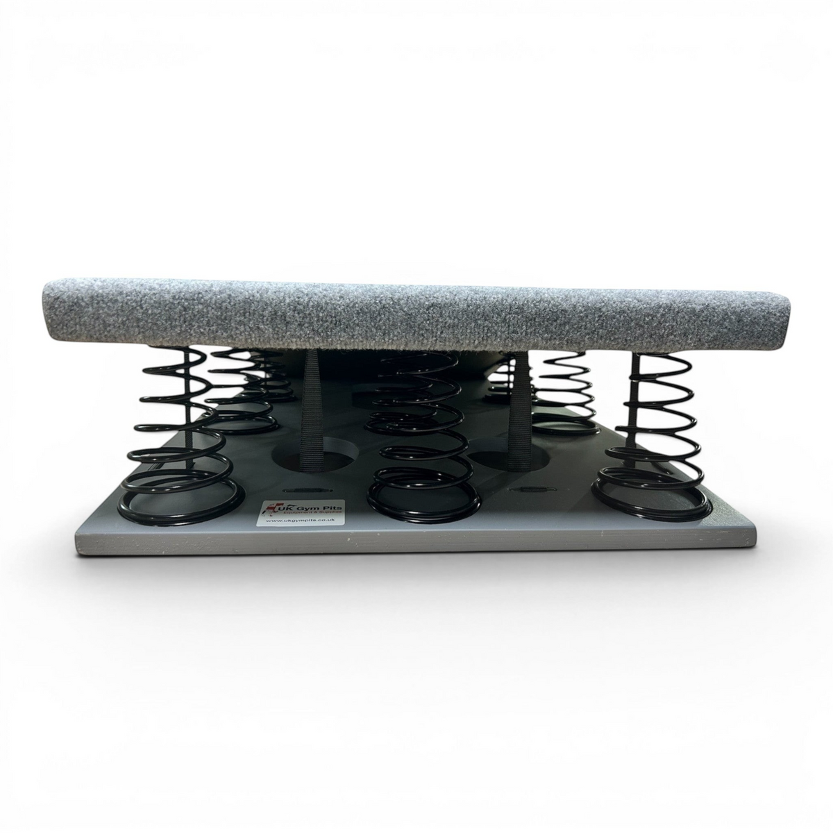 UK Gym Pits FIG approved gymnastics springboard with grey carpeted surface and black tapered steel springs