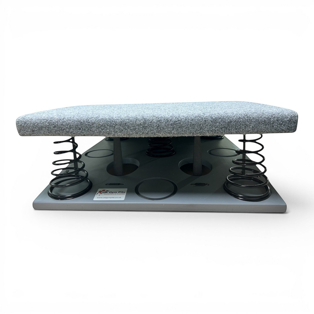 UK Gym Pits FIG approved gymnastics springboard with grey carpeted surface and black tapered steel springs