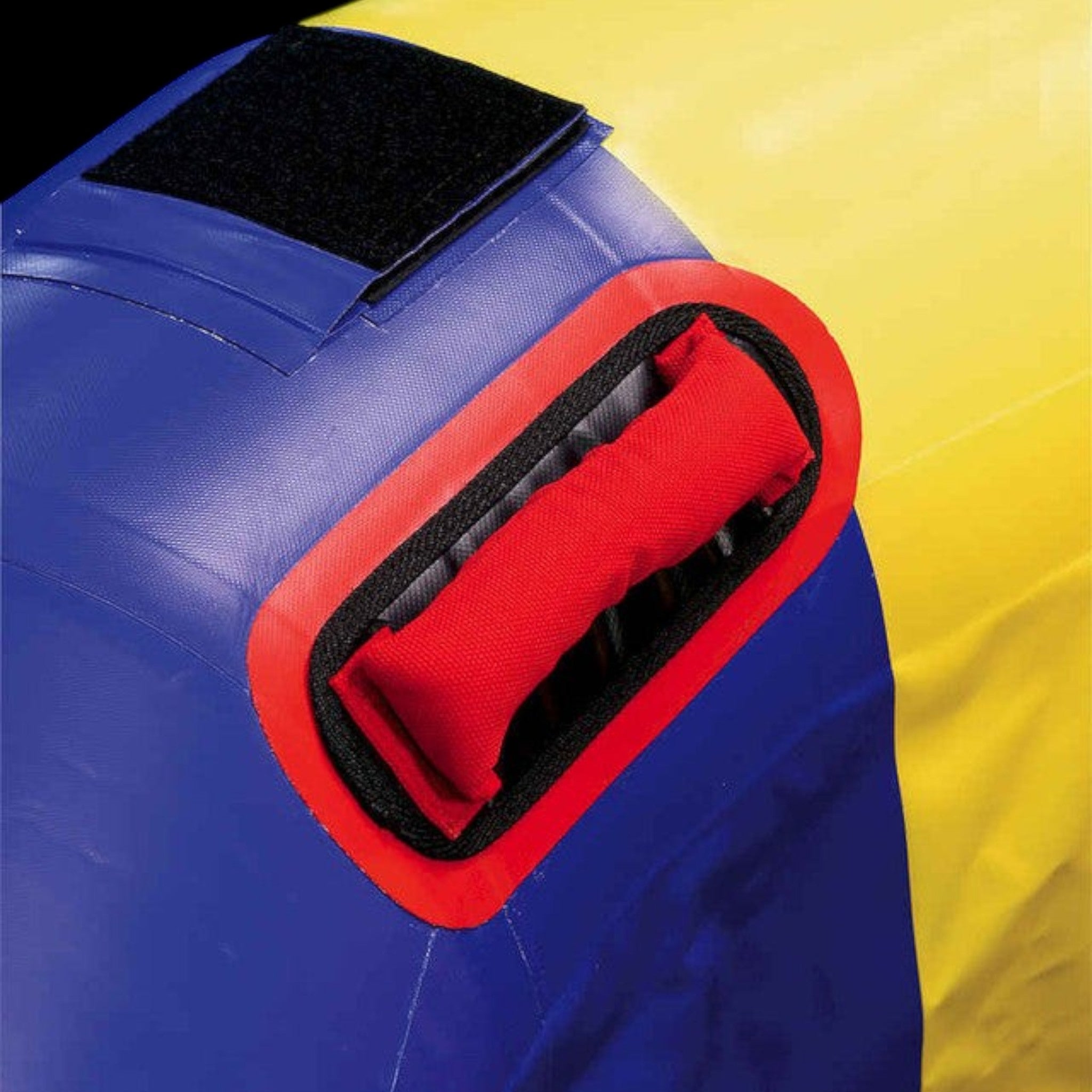UK Gym Pits fitness wheel featuring a durable red handle, blue and yellow panels, and a black velcro attachment square.