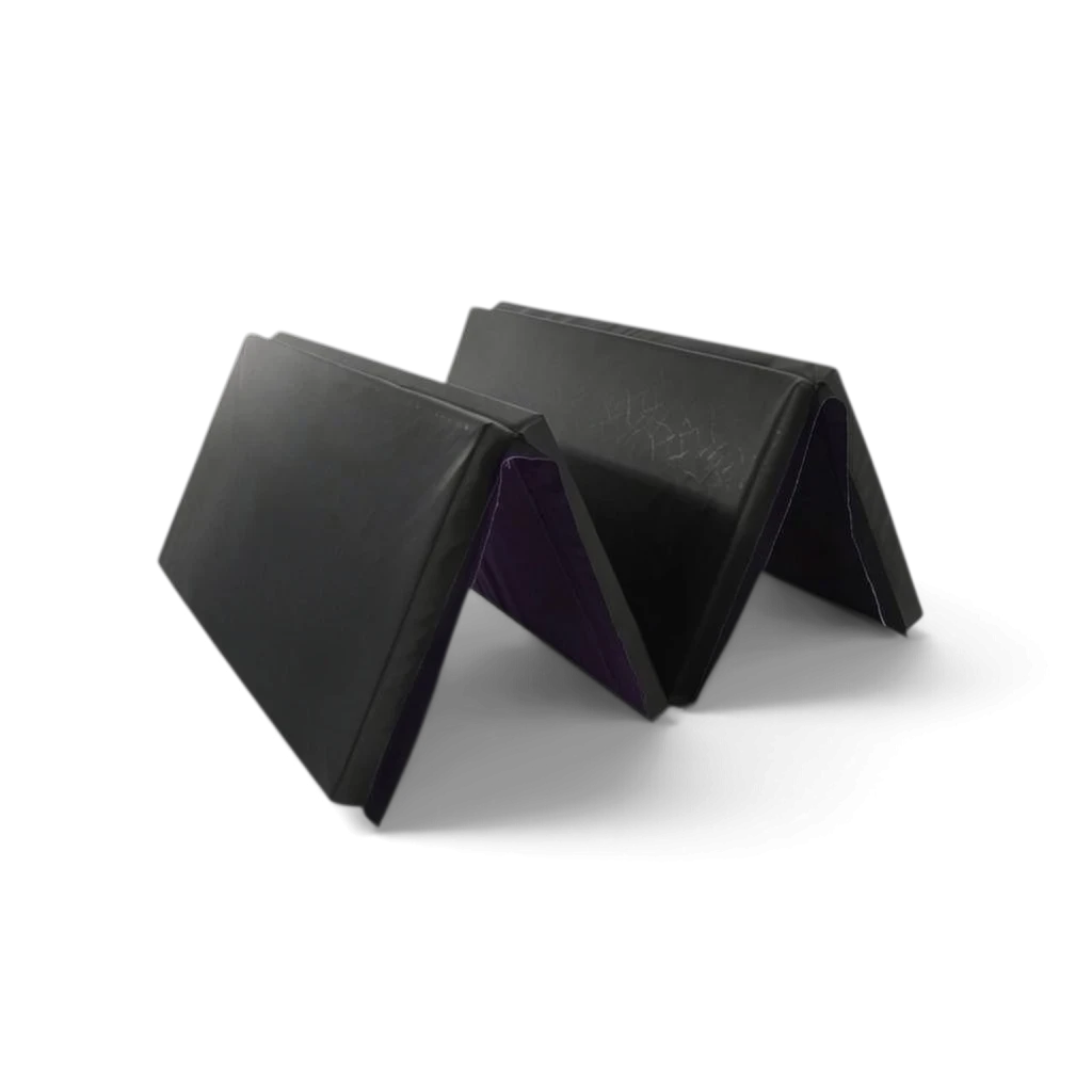UK Gym Pits foldable gymnastics mat in black and purple PVC, featuring a quarter-fold design for easy storage.