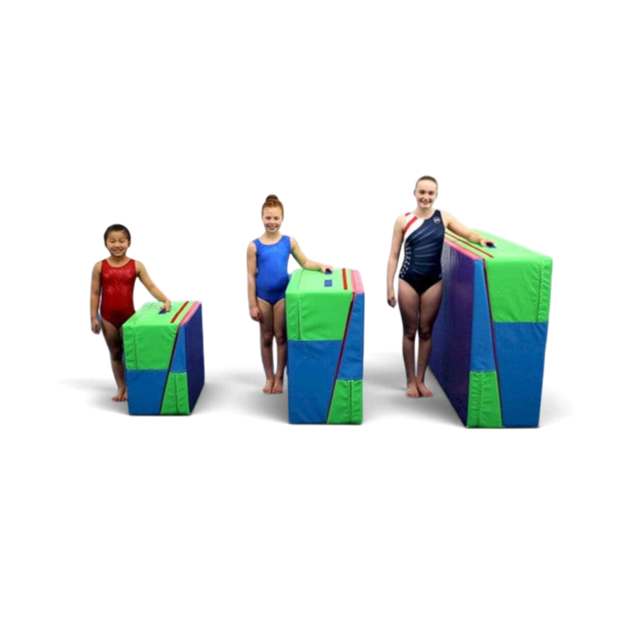 Three young gymnasts standing next to UK Gym Pits folding incline wedge mats in small, medium, and large sizes.