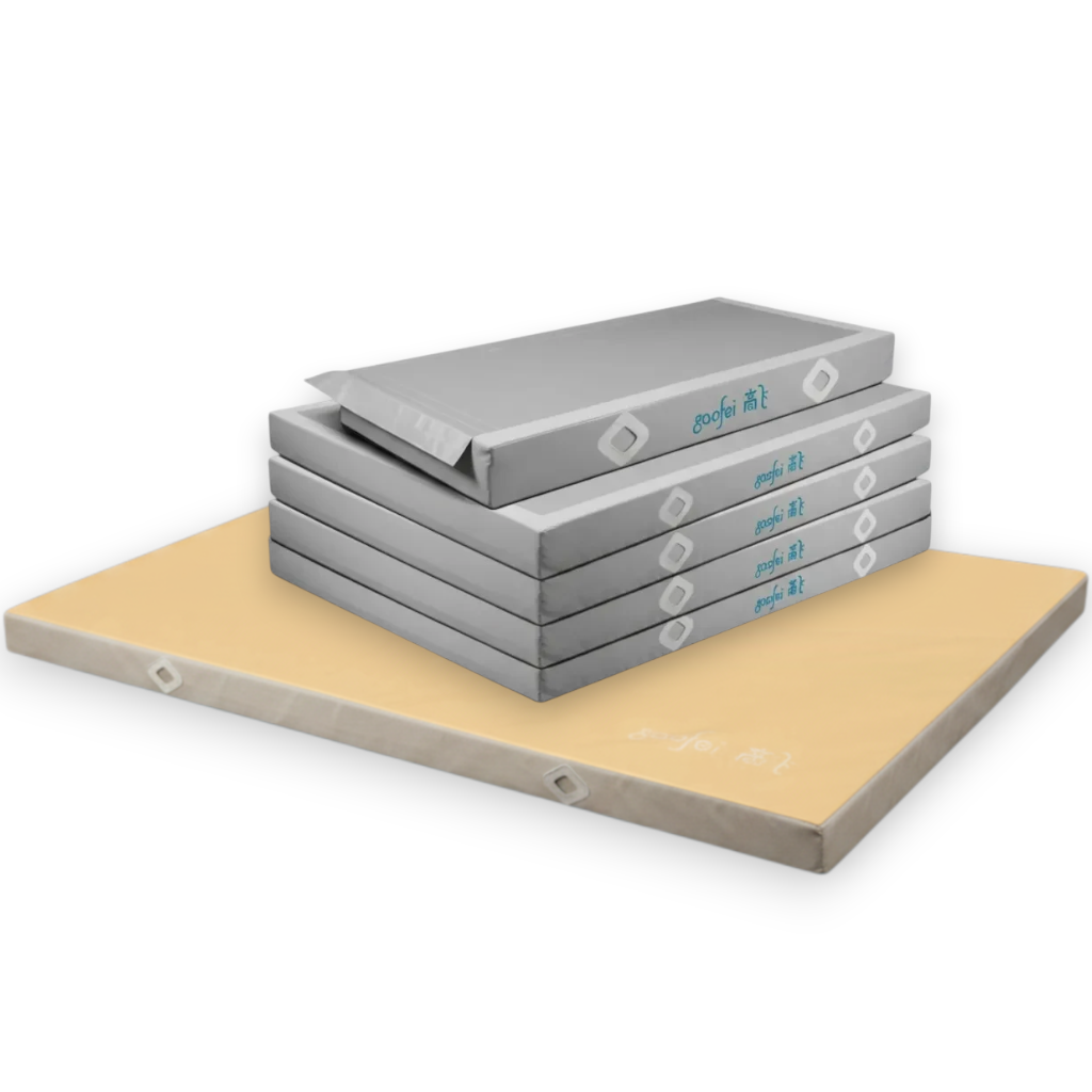 UK Gym Pits Gaofei FIG approved asymmetric bars landing mats with grey base units and a beige soft topper mat.