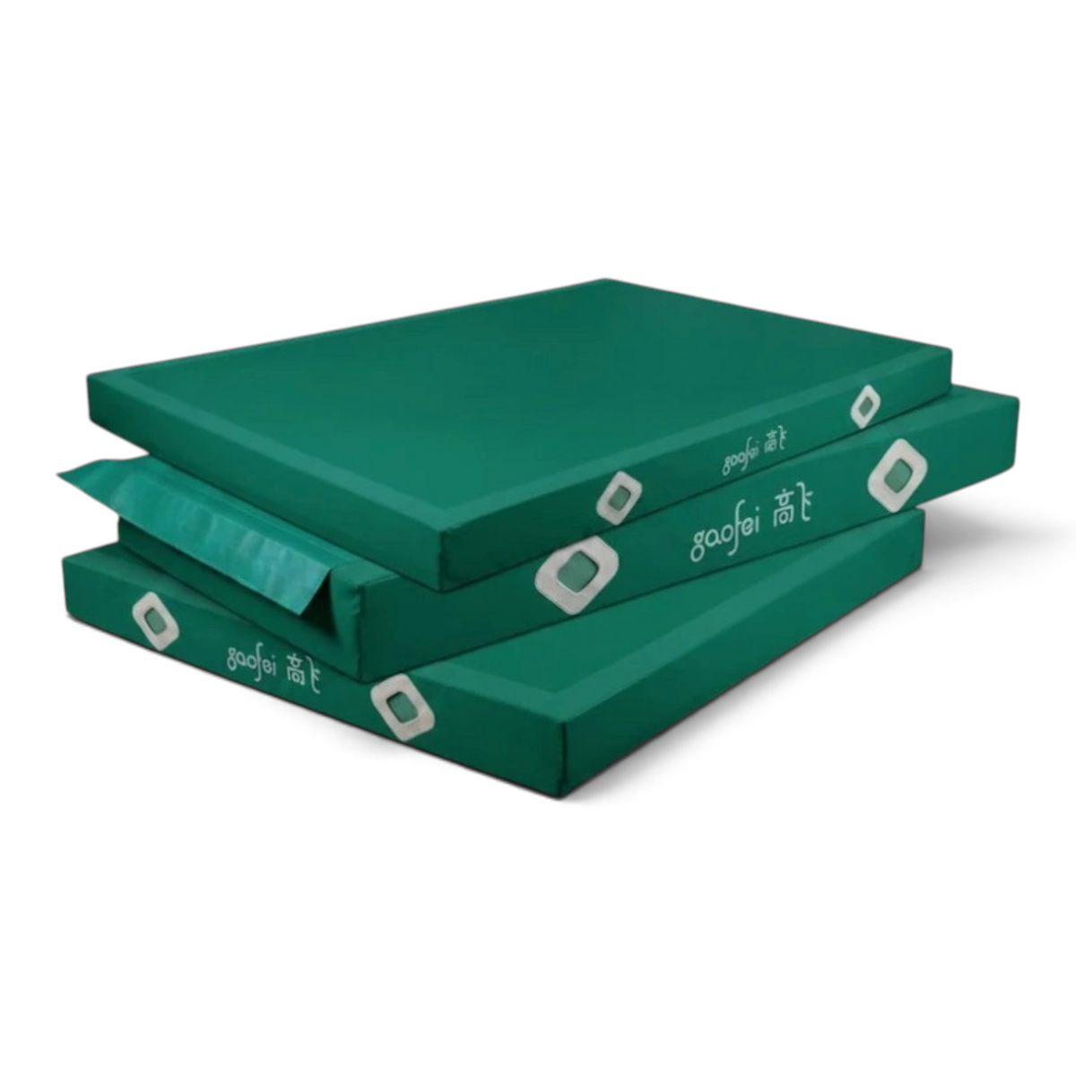 UK Gym Pits Gaofei FIG approved green gymnastics landing mats stacked for storage with durable PVC vinyl finish.
