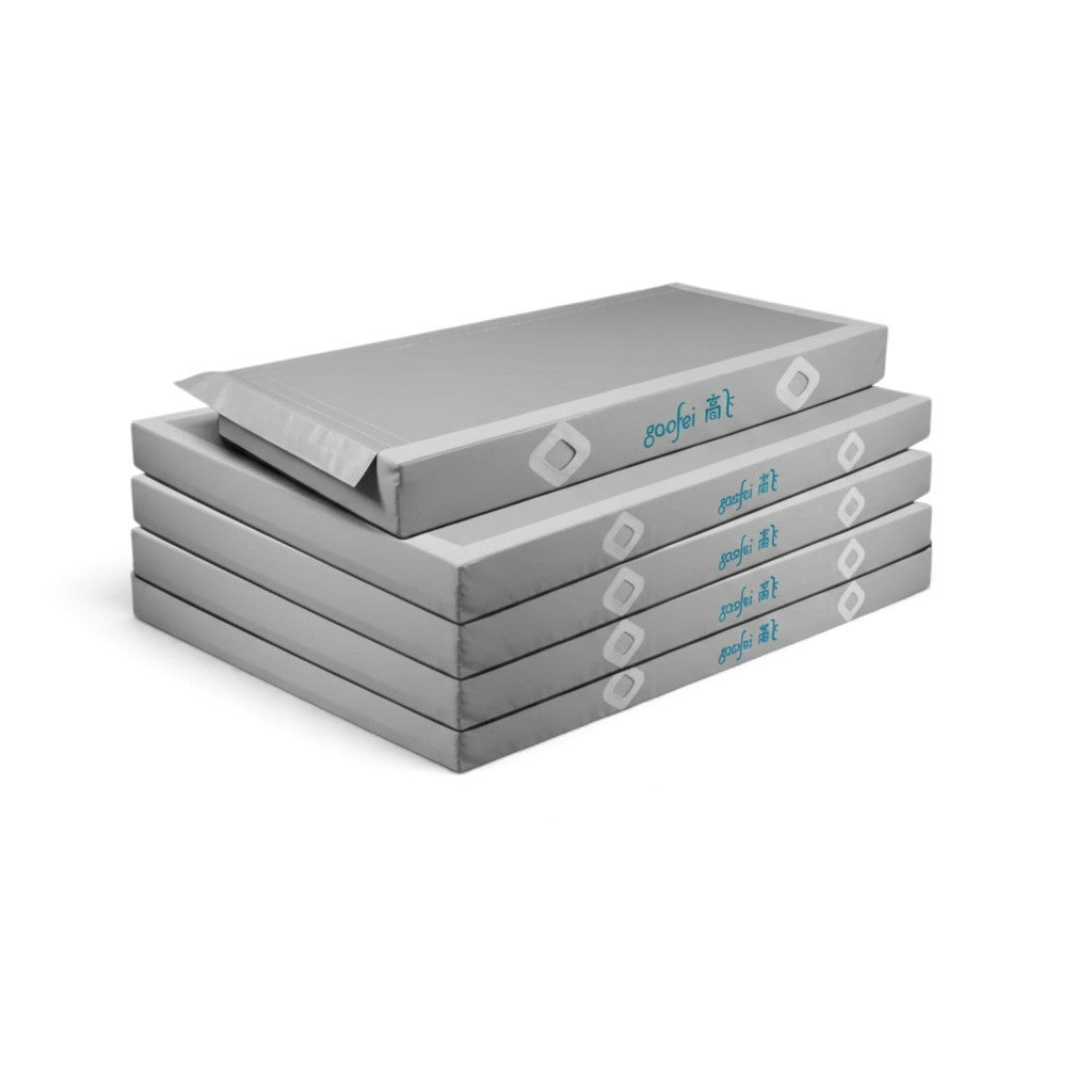 UK Gym Pits Gaofei grey asymmetric bars landing mats stacked for gymnastics training and competition use.