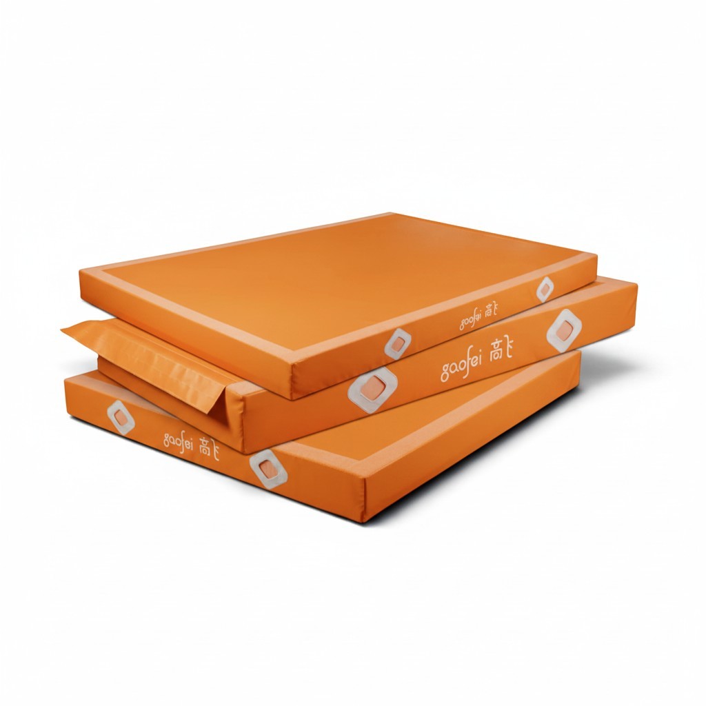 UK Gym Pits Gaofei orange gymnastics landing mats stacked, featuring durable PVC vinyl and air distribution mesh.