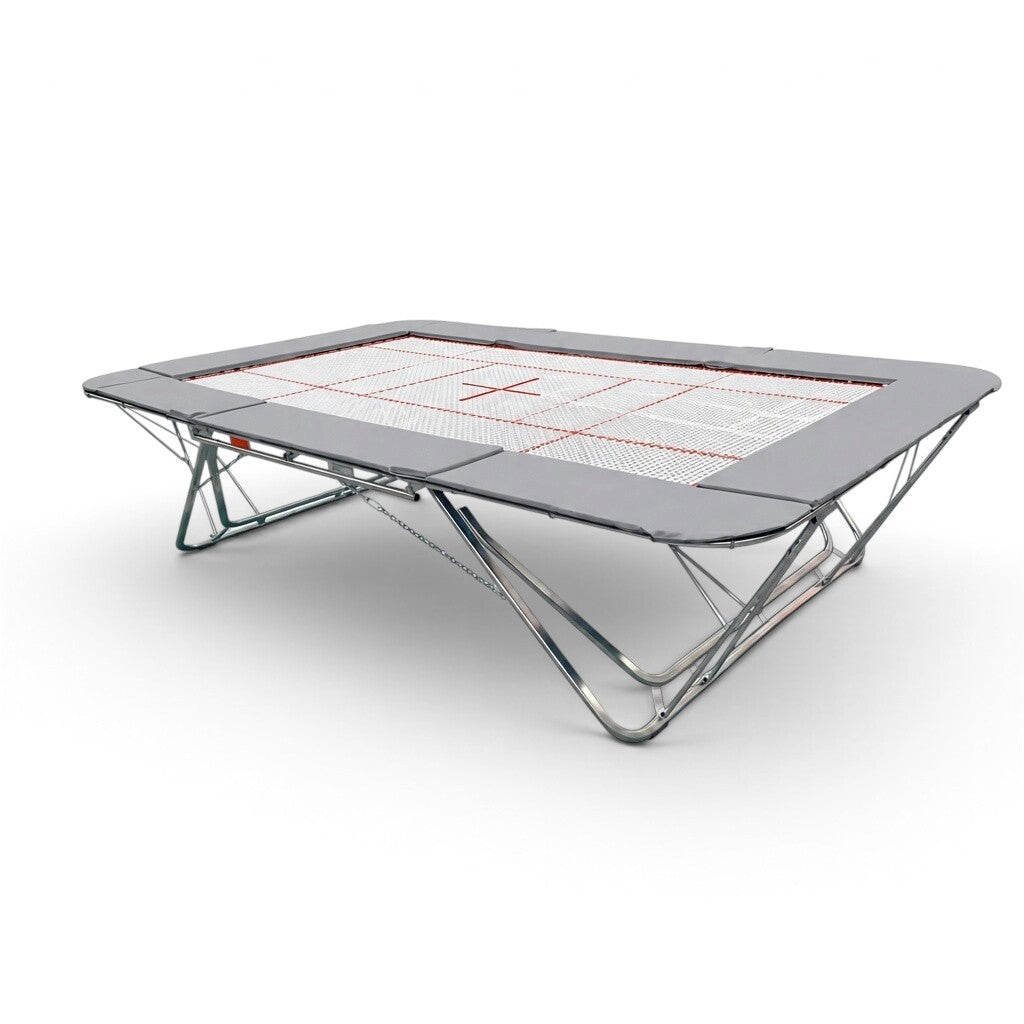 UK Gym Pits GMEX Extreme competition trampoline with grey frame pads and a white web bed on a white background.