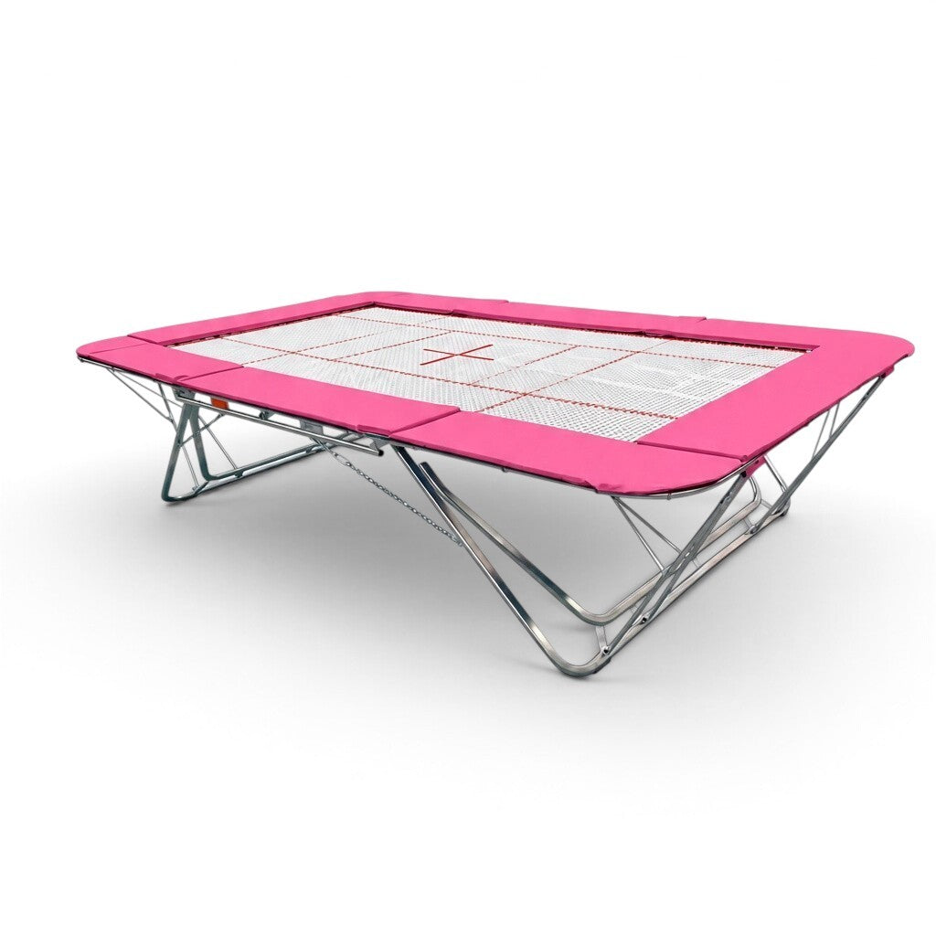 UK Gym Pits GMEX Extreme competition trampoline with a white web bed and vibrant pink protective frame pads