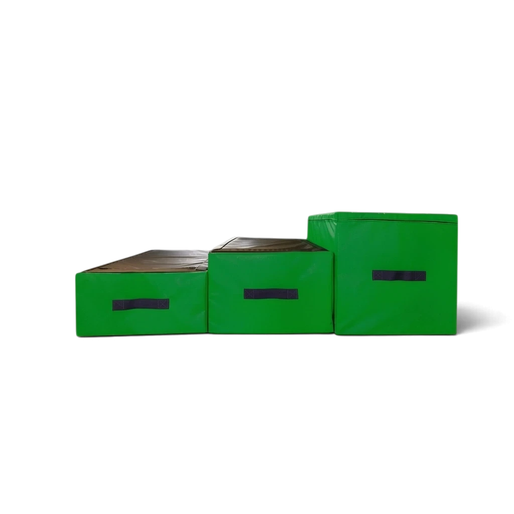 UK Gym Pits parkour jumping blocks in black and green with carry handles, arranged in a step formation.