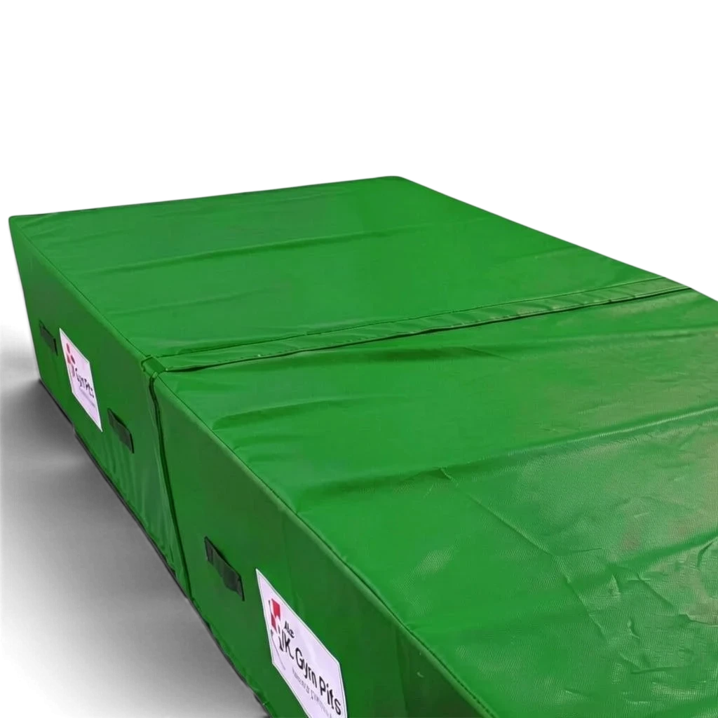 UK Gym Pits green heavy-duty foam track run-up block with anti-slip base and handles for gymnastics and parkour.