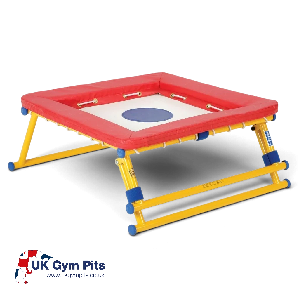 UK Gym Pits Gym Time Bouncer with a white jumping bed, red foam padding, and a yellow powder-coated steel frame.