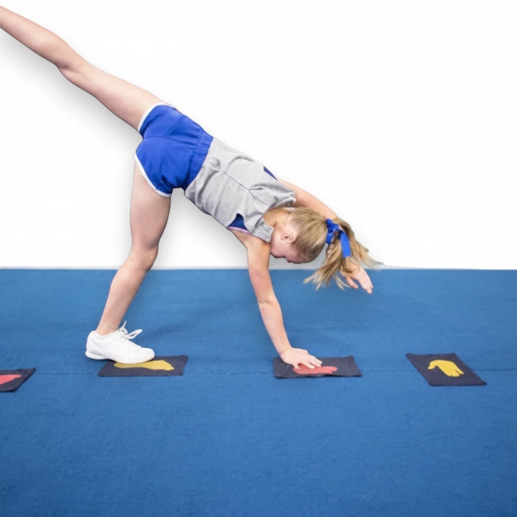 UK Gym Pits velcro hand and foot placement markers on blue mat with young gymnast practicing handstand technique
