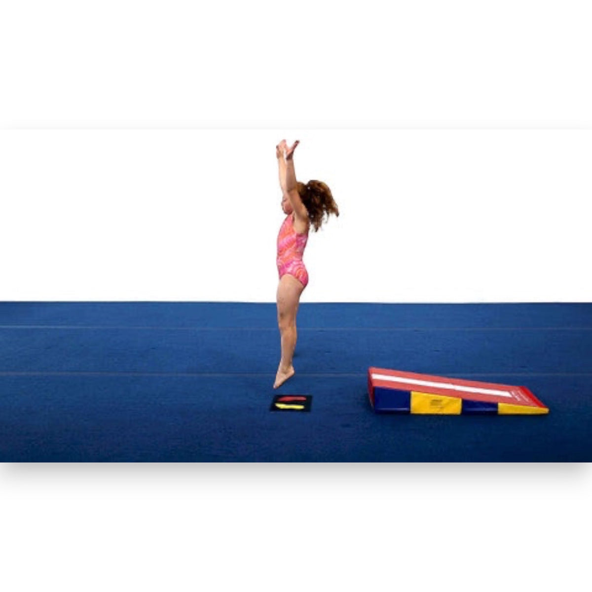 UK Gym Pits gymnastics markers showing hand and foot placement on a blue mat with a young gymnast jumping nearby