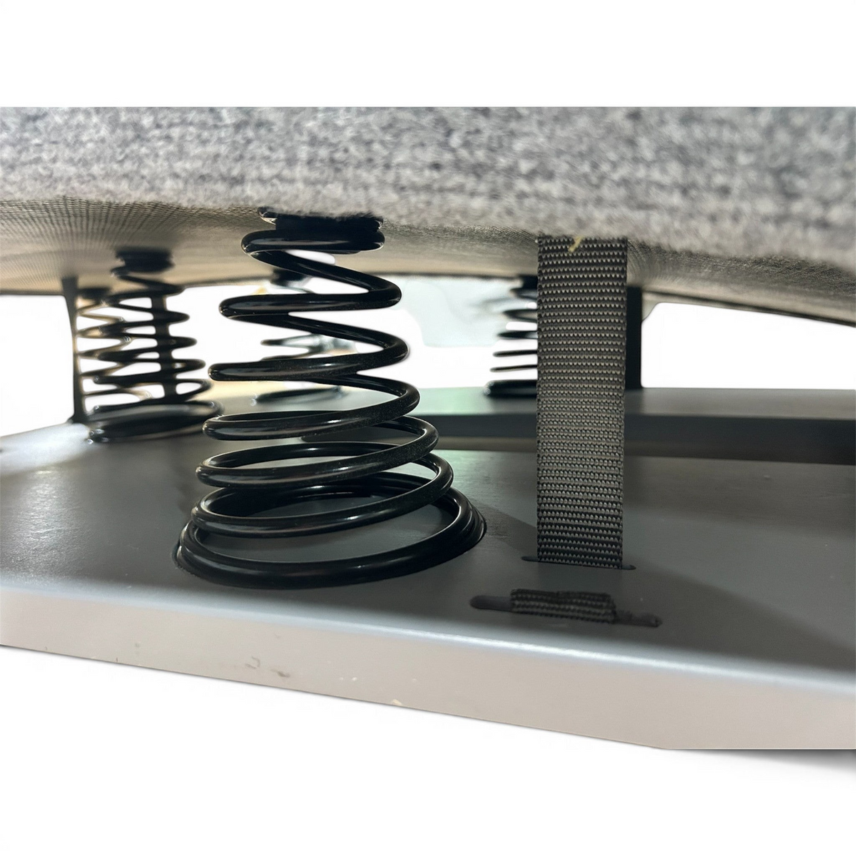 UK Gym Pits FIG approved springboard showing black tapered HDI springs and grey carpeted surface for gymnastics