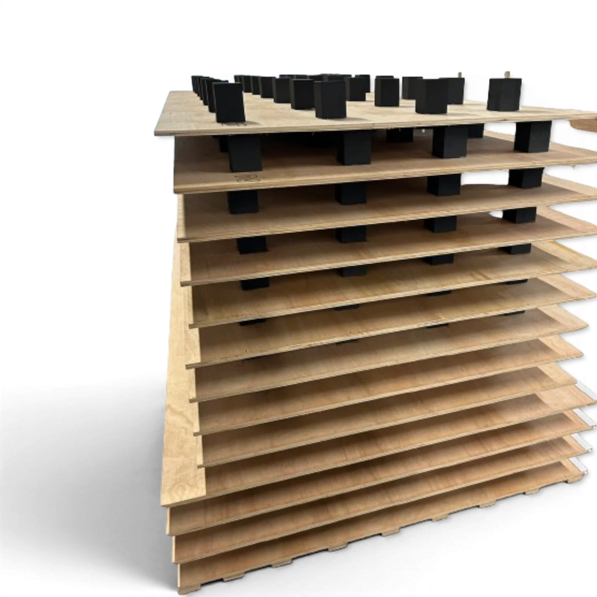 UK Gym Pits gymnastics sprung floor showing stacked plywood panels with pre-installed black EDPM foam blocks.