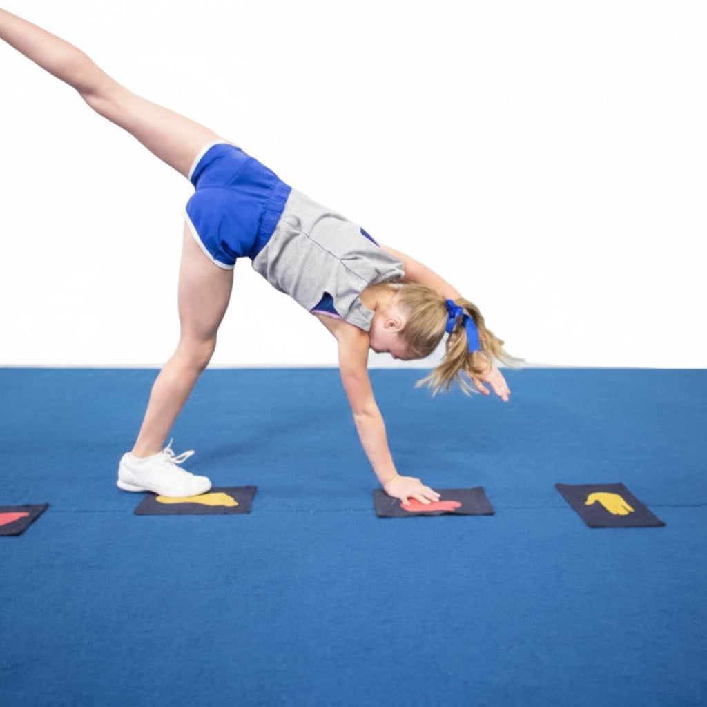 UK Gym Pits Hands & Feet denim markers on a blue mat with a young gymnast practicing a handstand