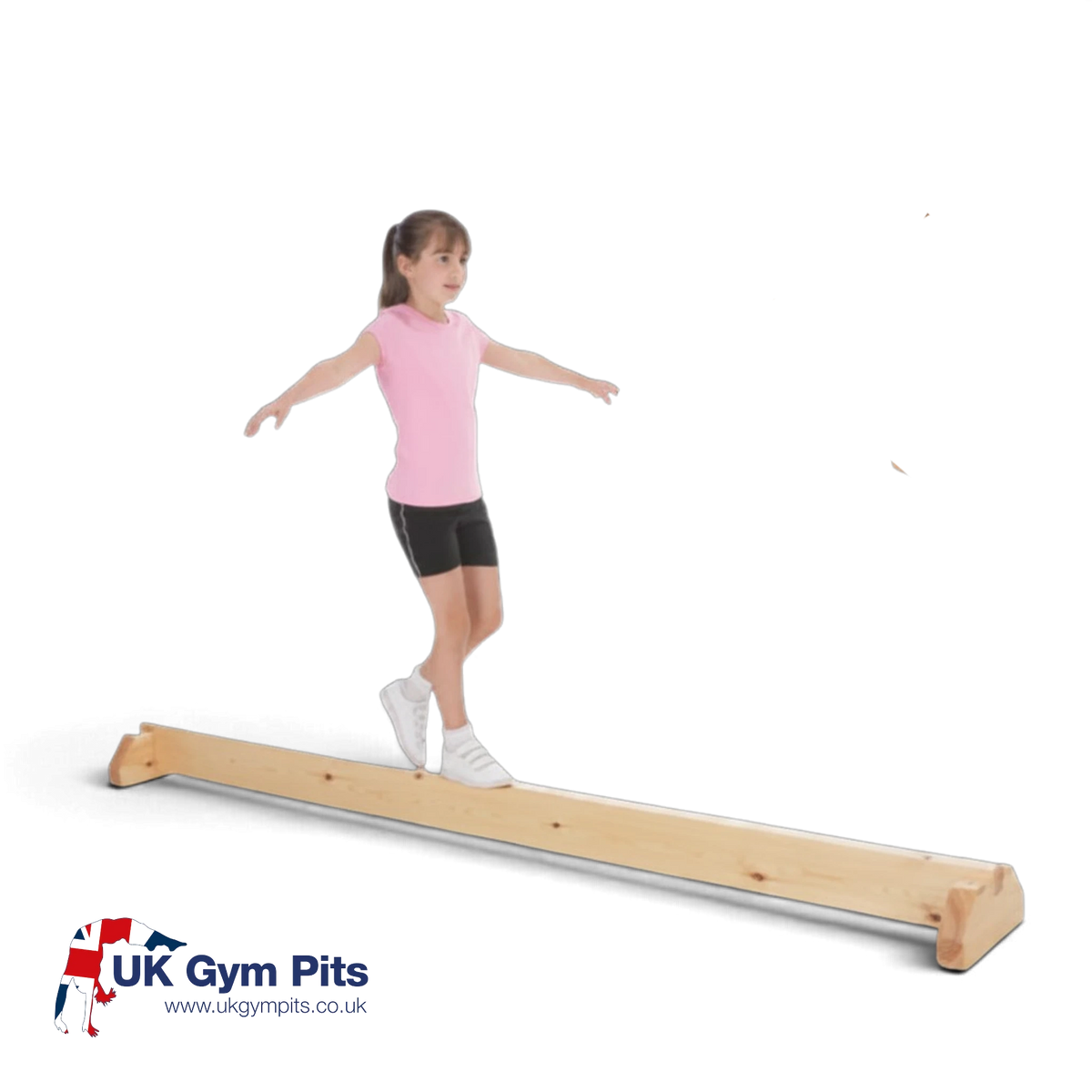 Young girl practicing on a UK Gym Pits junior natural timber balance beam with stable wooden support legs.