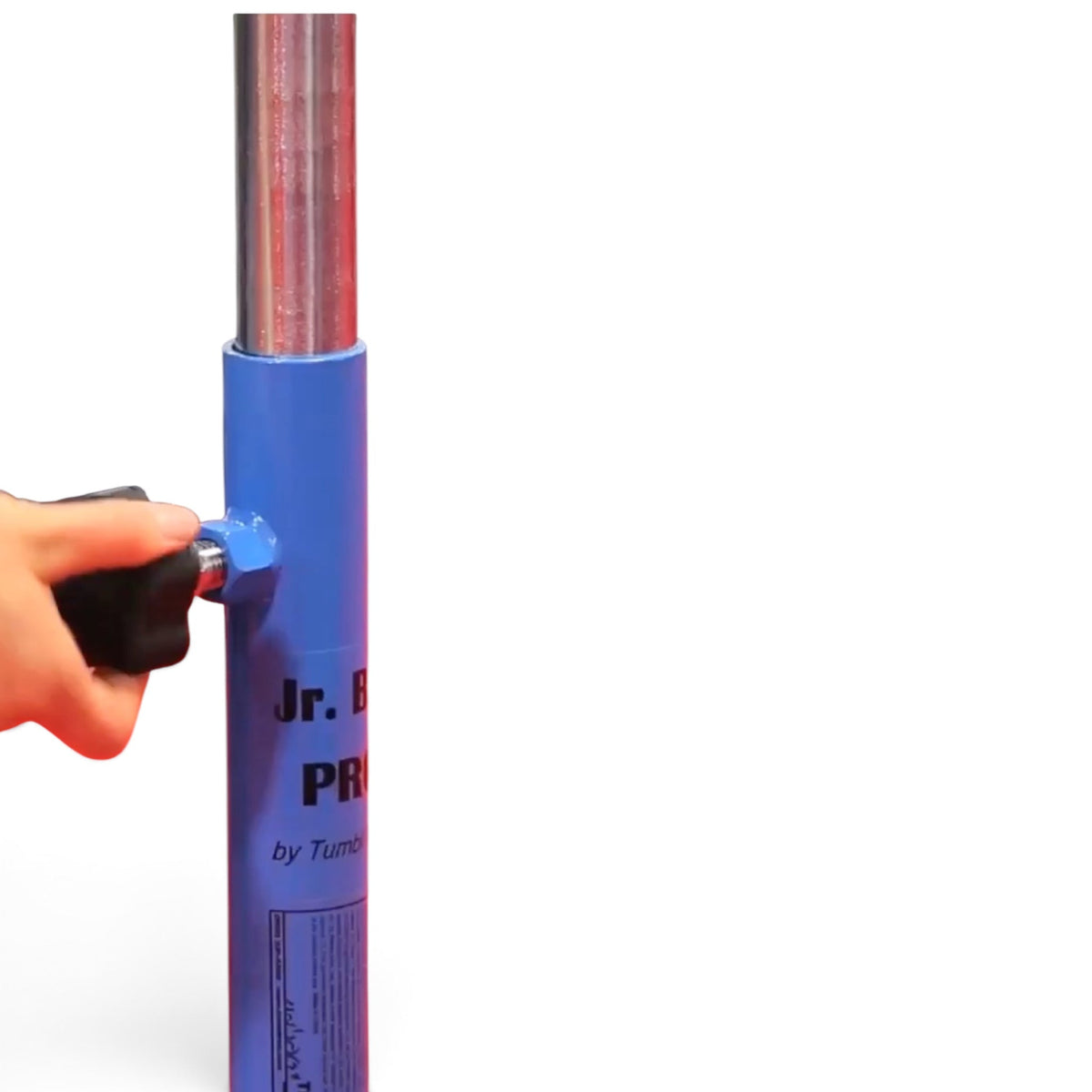A hand adjusting the ergonomic hand-wheel on a blue UK Gym Pits Junior Training Bar Pro steel frame.