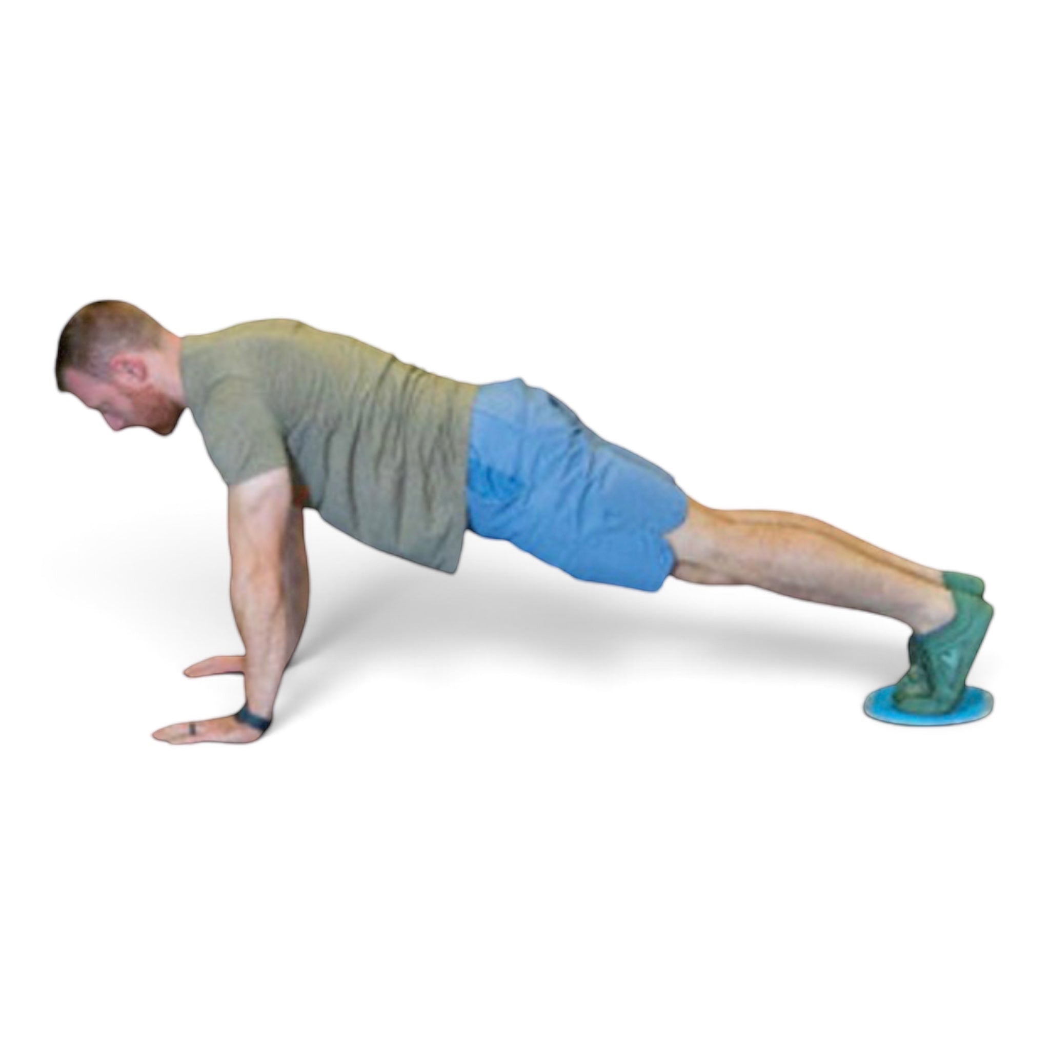 Athlete performing a plank exercise using a UK Gym Pits large conditioning slider under his feet