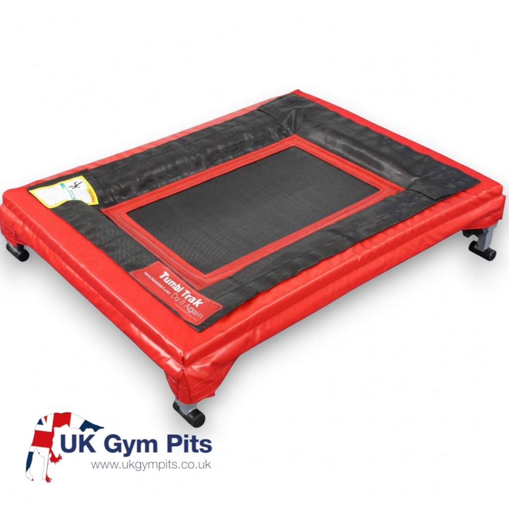 UK Gym Pits Tumbl Trak Mini Trak with a black polypropylene bed, red safety pads, and an aluminium frame.