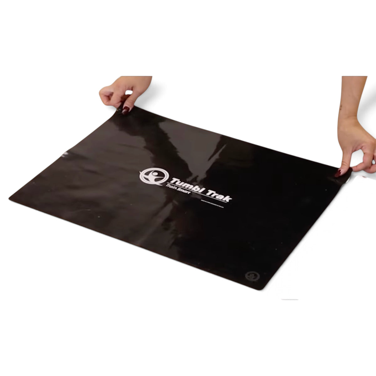 UK Gym Pits non-slip smart mat sheet in black silicone with glossy finish being held by hands for gym safety