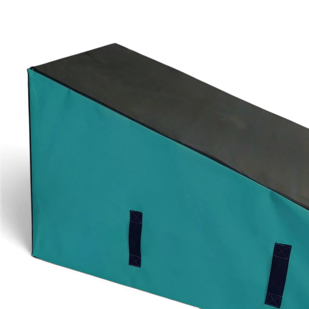 UK Gym Pits parkour wedge block in black and teal with carry handles for freestyle gymnastics and tricking training.