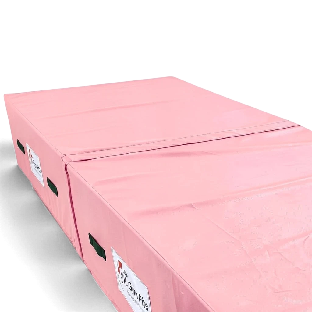 UK Gym Pits pink high-density foam track run-up block with heavy-duty handles and reinforced PVC fabric cover.