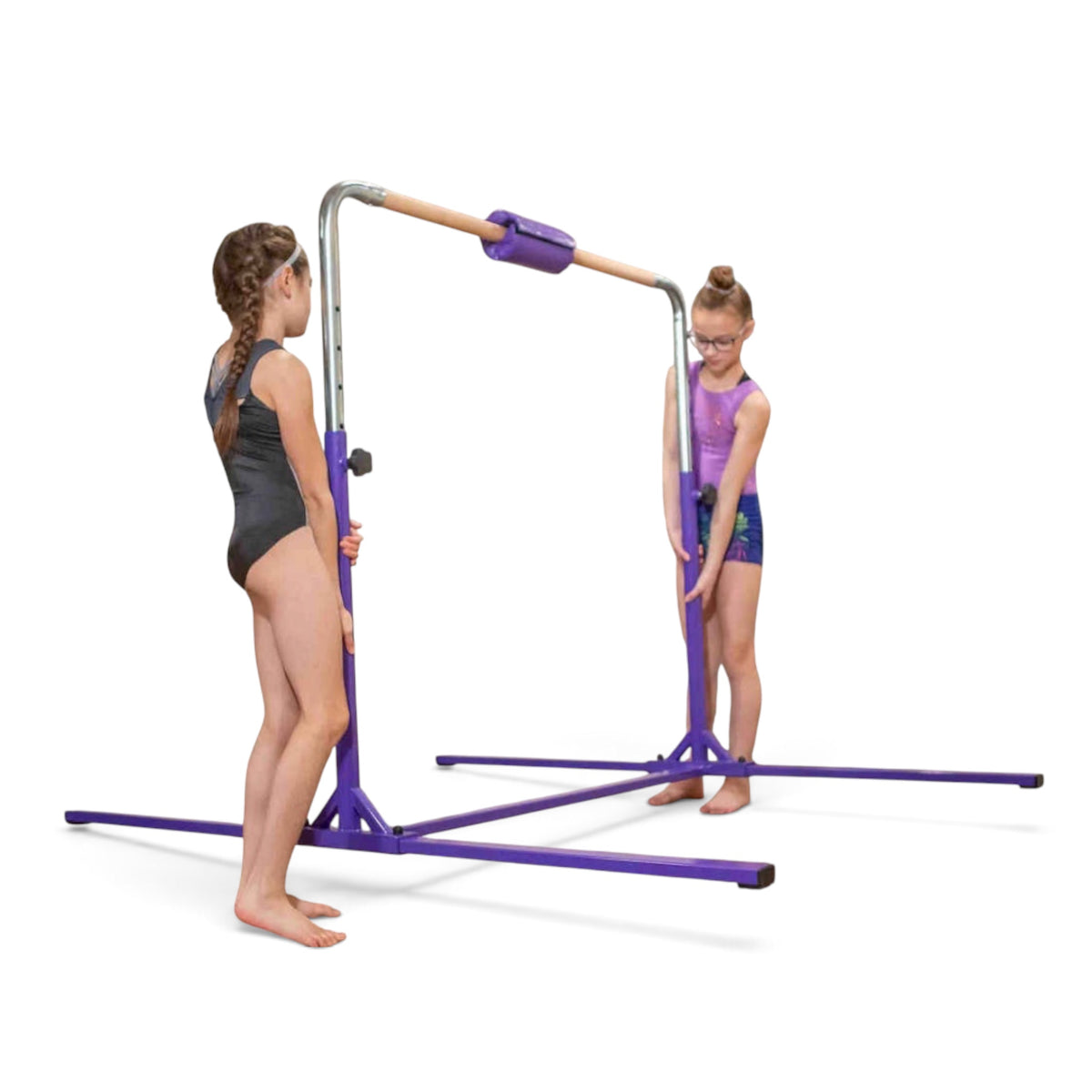 Two young gymnasts adjusting the height of a purple UK Gym Pits kip bar with a solid maple wood rail.