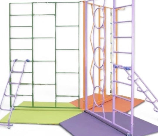 UK Gym Pits rainbow climbing frame with colourful steel gates, ladders, and safety mats for school gymnastics.