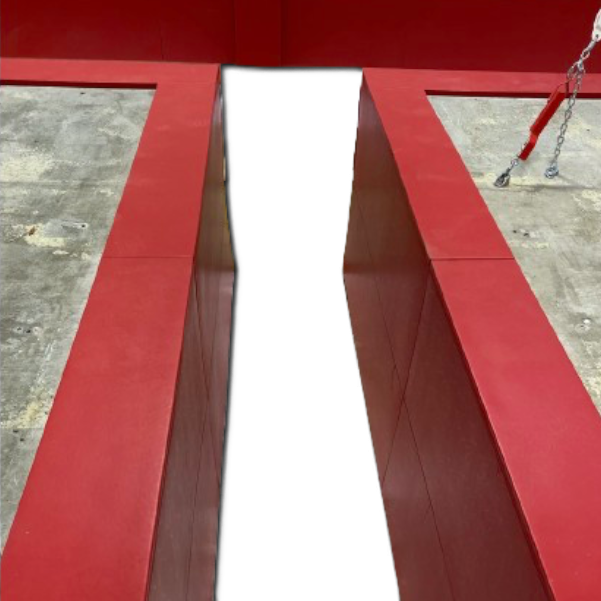 UK Gym Pits red PVC foam padding installed on the walls and top edges of a gymnastics landing pit.