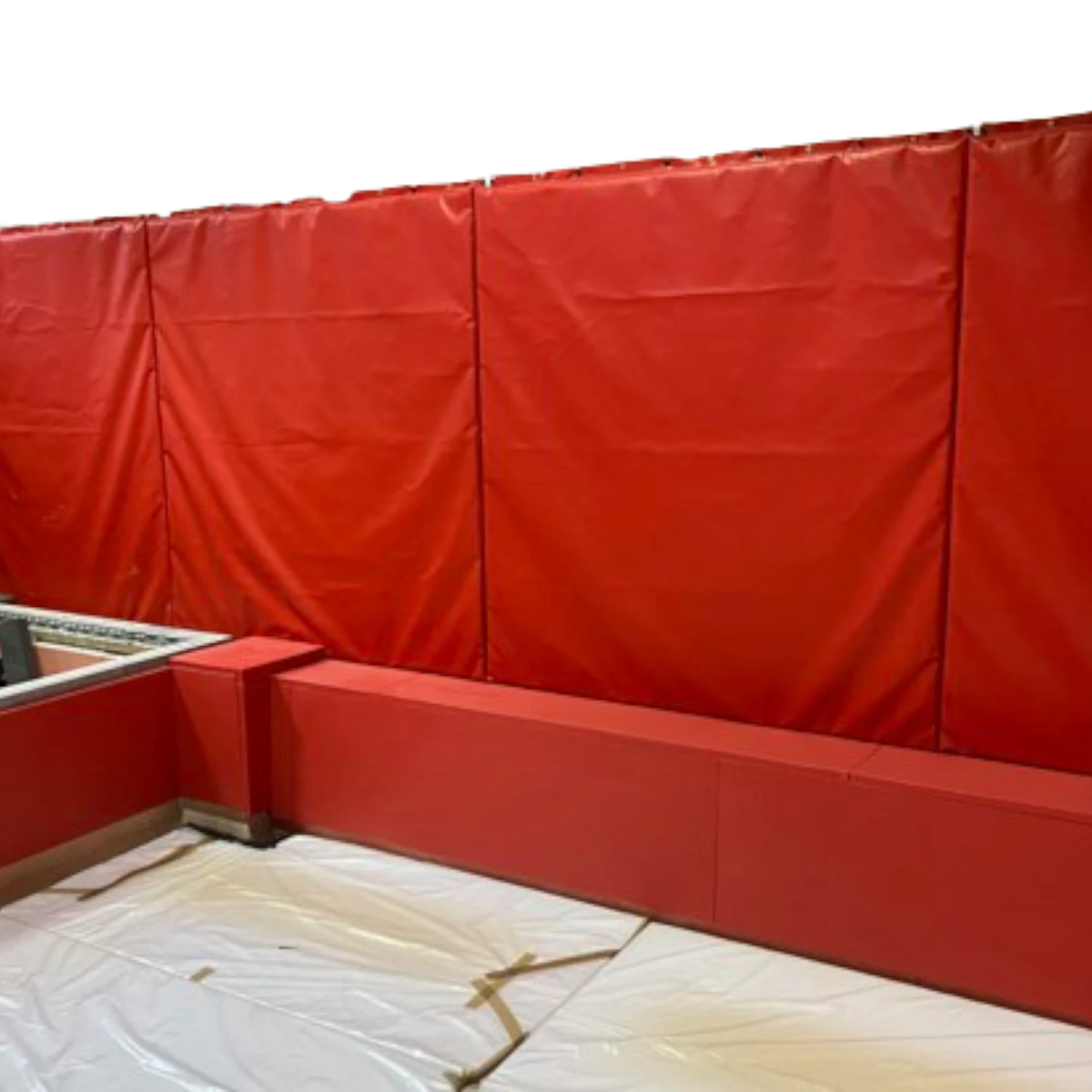 UK Gym Pits red PVC foam wall and top edge padding installed in a gymnastics landing pit area.
