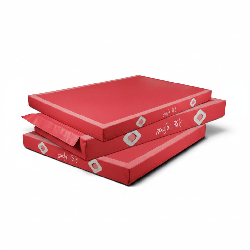 UK Gym Pits Gaofei red gymnastics landing mats stacked, featuring durable PVC vinyl and air distribution mesh.