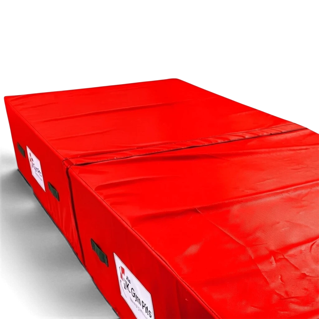 UK Gym Pits red heavy-duty foam track run-up block with reinforced PVC cover, handles, and anti-slip base.