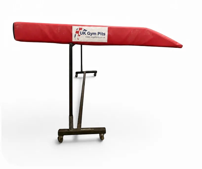 UK Gym Pits red single wedge trampoline spotting end deck mat with reinforced PVC cover on a metal frame