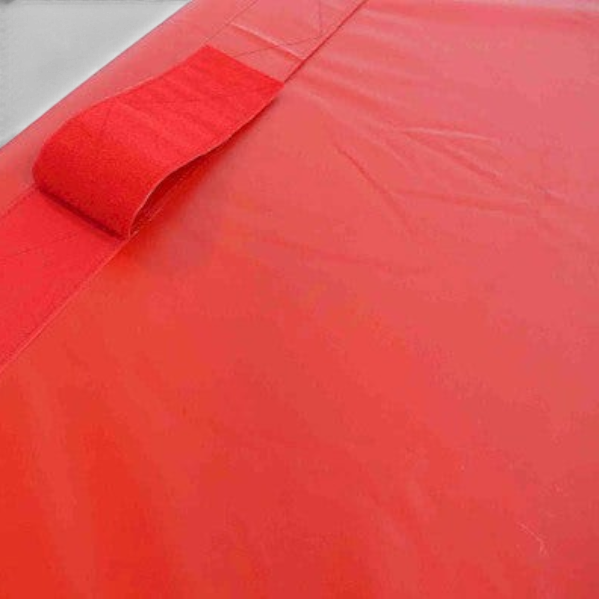 UK Gym Pits red vinyl practice crash mat featuring a reinforced nylon web handle and secure velcro fastener