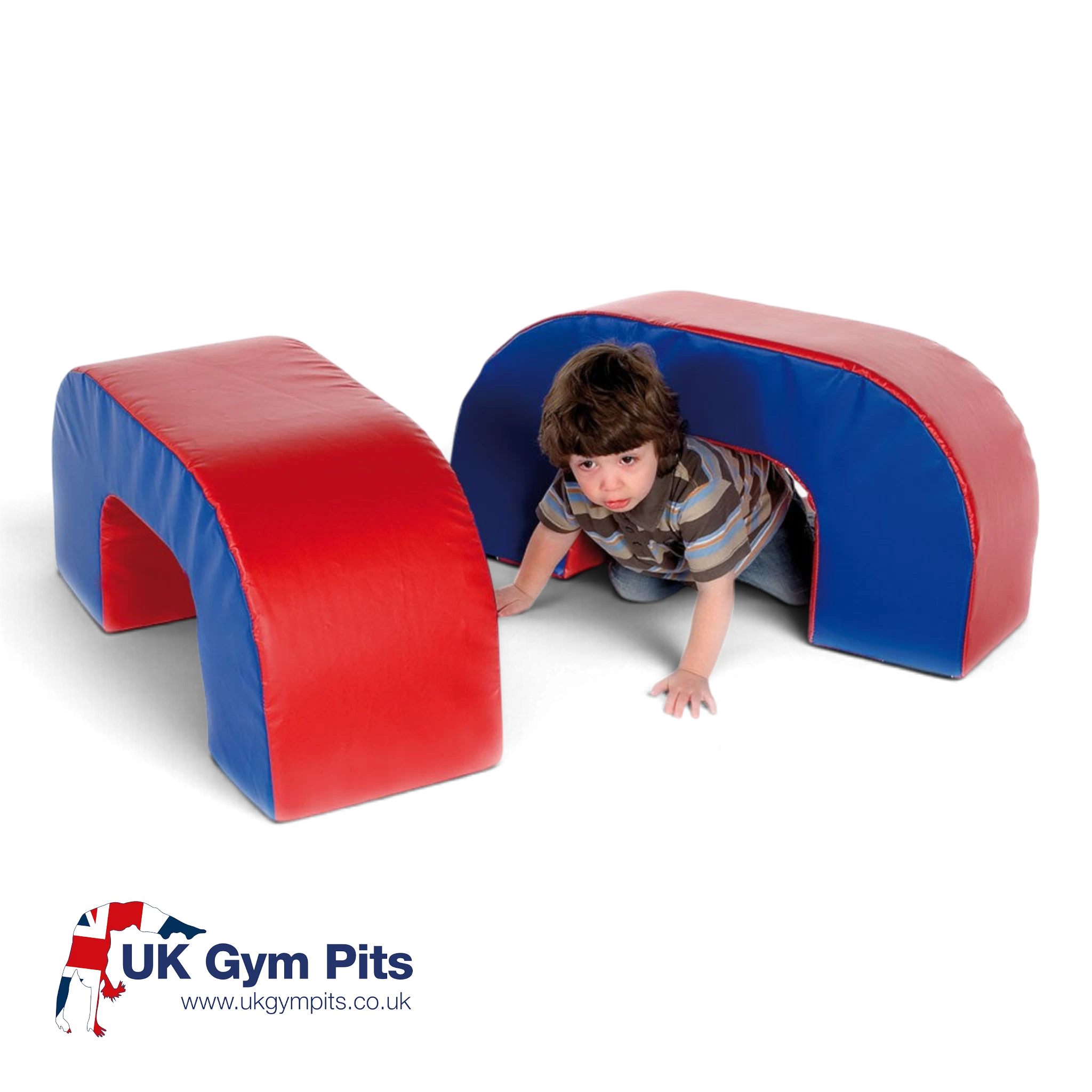 UK Gym Pits soft play arches in red and blue vinyl, being used by a child to crawl through for motor skill development.