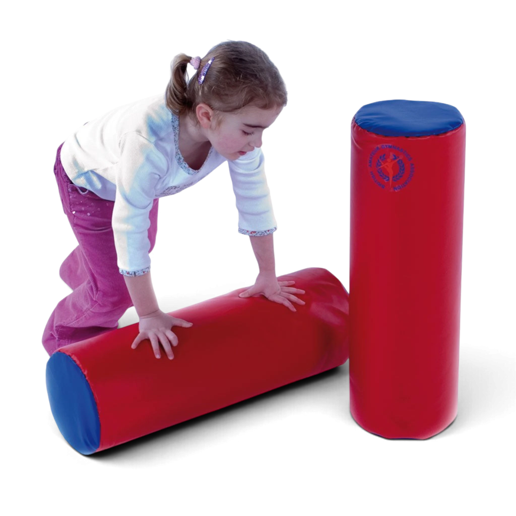 A young girl playing with UK Gym Pits soft play red and blue foam cylinders for gross motor skill development.