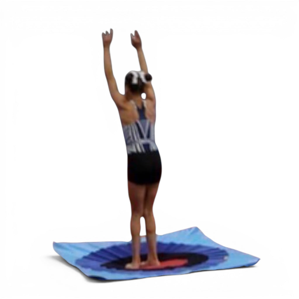 UK Gym Pits Spencer Spot Landing Dot with a gymnast standing on the bullseye target mat for precision training