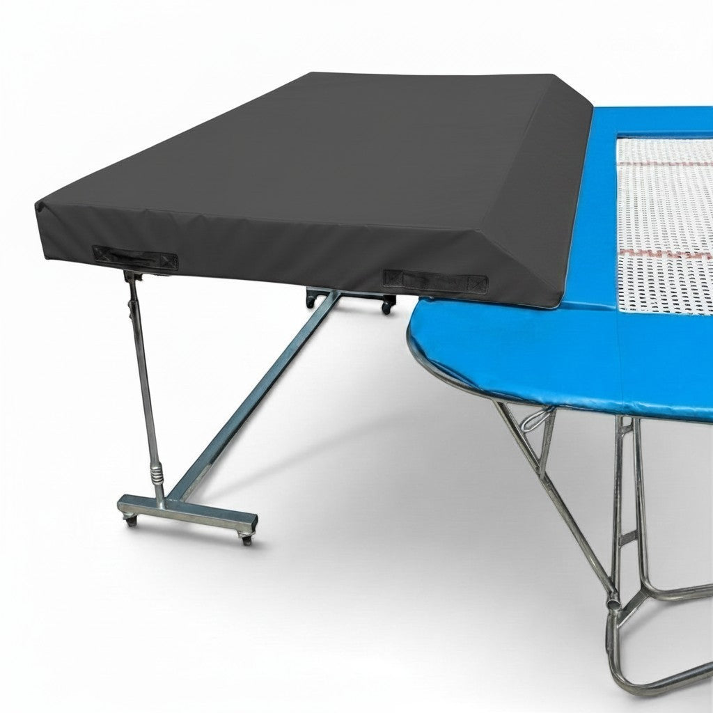 UK Gym Pits international spotting end deck with a grey wedge safety mat attached to a blue competition trampoline