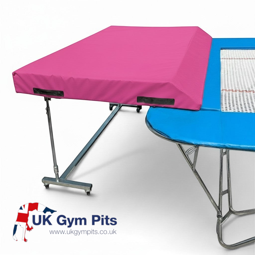 UK Gym Pits international spotting end deck with a pink wedged safety mat attached to a trampoline frame